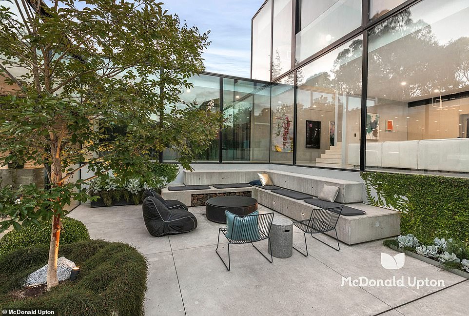 Outside, vines surround a lawn and 15-metre heated swimming pool, while built-in concrete seating creates a relaxing entertainment area with a fire pit