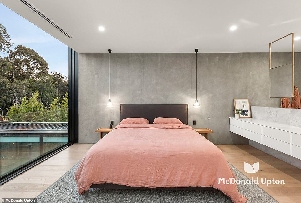 Upstairs is the master bedroom with a Juliette balcony overlooking the gardens below and an open plan bathroom with elegant copper fittings, a freestanding bath and floating mirrors above a marble double sink.