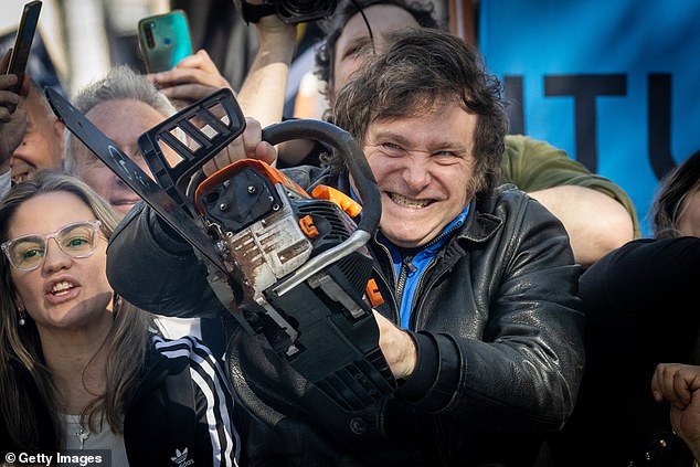 Javier Milei won Argentina's presidential election in November with 56% of the vote, using some unorthodox tactics.  Pictured holding up a chainsaw during one of his rallies