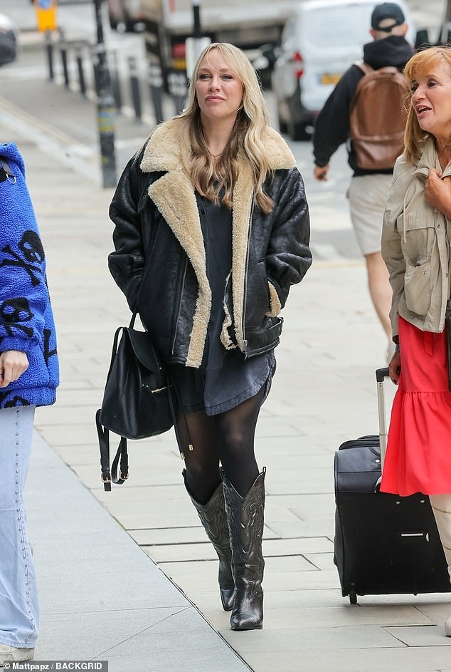 She completed her look with black heeled cowboy boots and wore a fashionable sheepskin jacket