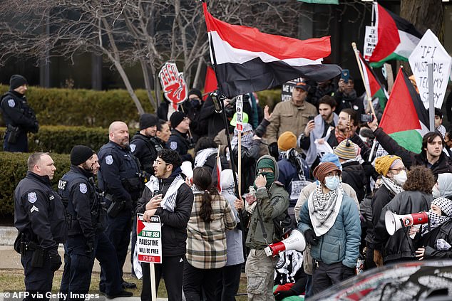 People gather in support of Palestinians outside the site where President Joe Biden speaks with members of the United Auto Workers (UAW) in Michigan