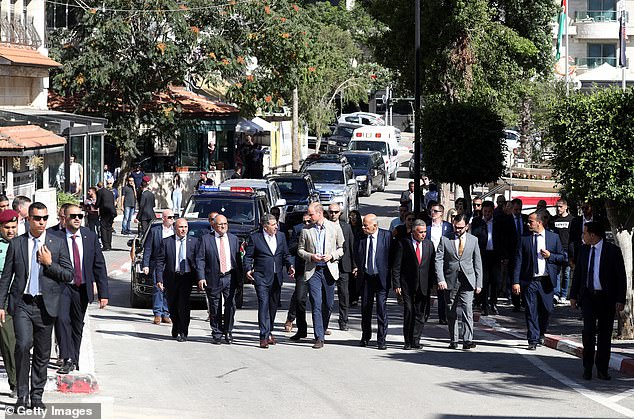 The prince is escorted by security in Ramallah during his official tour of the Middle East in 2018