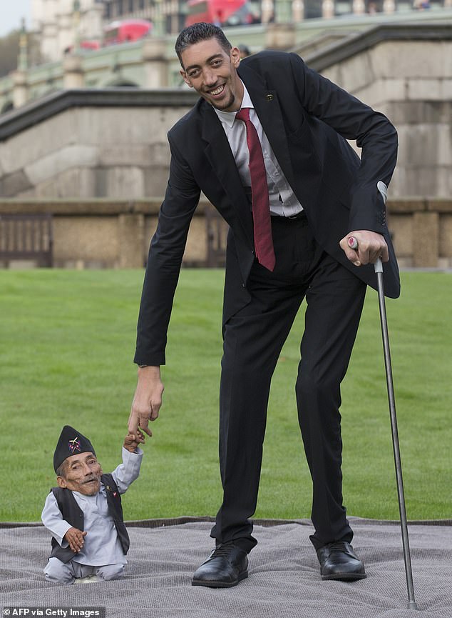 Chandra Bahadur Dangi, from Nepal, (L) the smallest adult ever verified by Guinness World Records, is pictured with the world's tallest man Sultan Kosen from Turkey in 2014