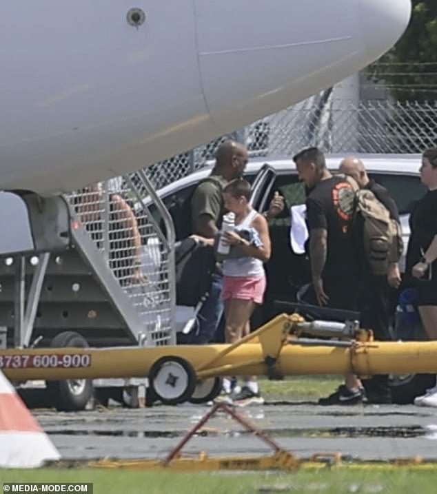 Husband Carey, 48, also kept it light and simple in the Queensland heat, wearing a black T-shirt and shorts.  Daughter Willow is shown wearing pink shorts