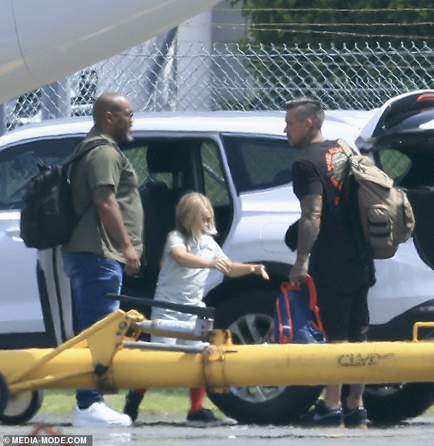 Meanwhile, seven-year-old Jameson ran onto the plane wearing a light blue T-shirt and shorts, paired with bright red socks and black sneakers.