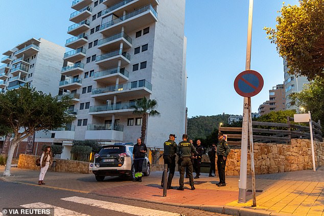 Officers from Spain's Guardia Civil stand outside the garage where the body of Russian pilot Maksim Kuzminov was found after he was shot dead