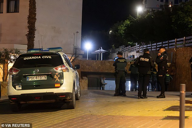 Spanish detectives have launched an investigation into the pilot's death.  Pictured: Spanish Guardia Civil officers at the garage where Kuzminov's body was found