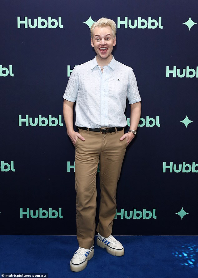 Funnyman Joel Creasey rocked a white button-up shirt with short sleeves, tan pants and white sneakers