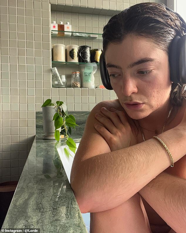 With her hair soaking wet, Lorde listened to music in black headphones and wore an array of gold jewelry