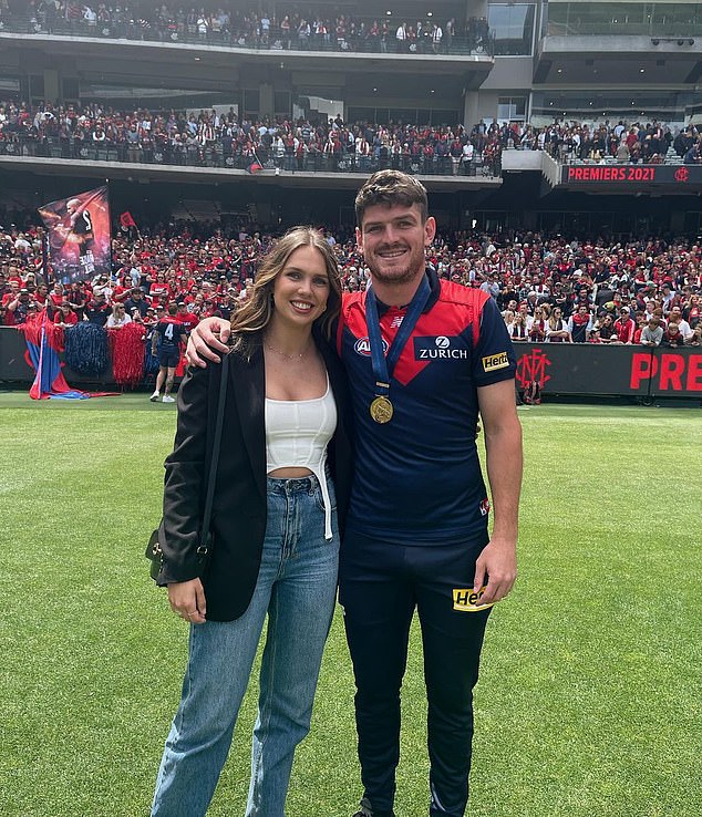 The 28-year-old (pictured with fiancée Danielle Frawley) said he was 'able to fulfill my childhood dream' during his 167-game career