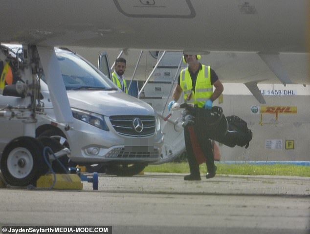 Staff were seen unloading the golf clubs from the plane and taking them to his driver's vehicle