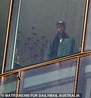 Travis Kelce was spotted admiring the view from a lavish Sydney hotel room after landing in Australia on Thursday morning