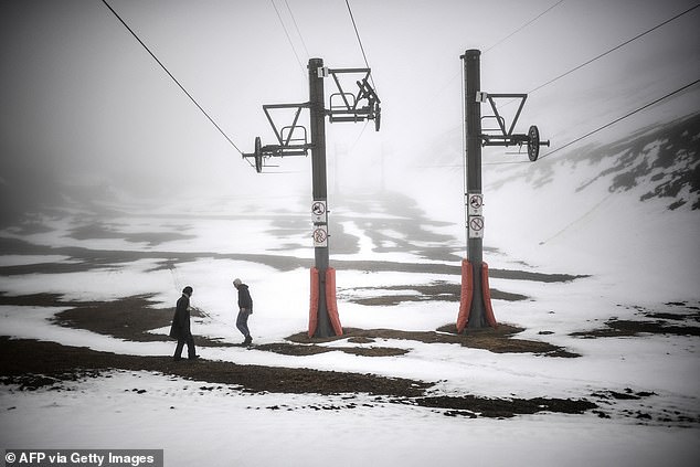 FRANCE: People walk across a patchy snow cover in the Artouste ski resort on Monday