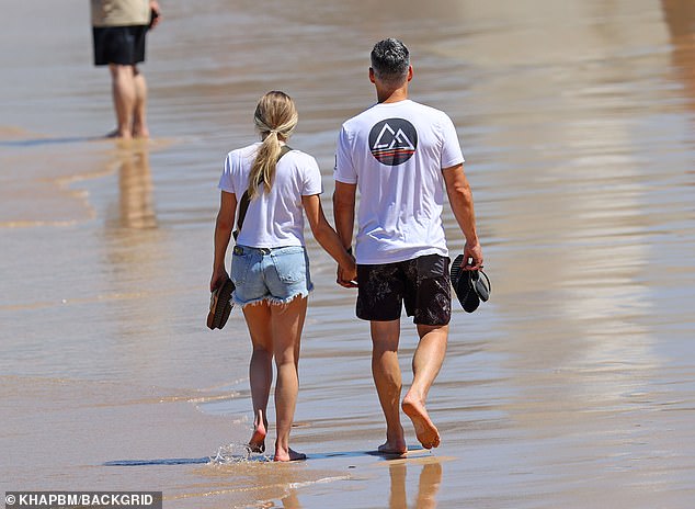 LeAnn held hands and stayed close to her handsome movie star husband Eddie, 50, who looked equally beach-ready in a white T-shirt and black board shorts