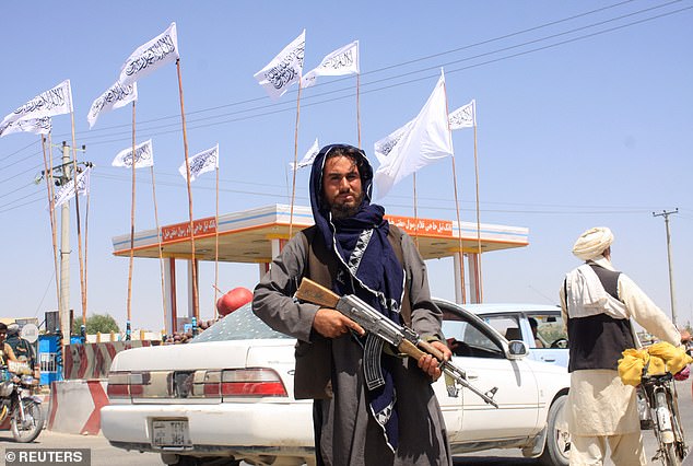 A Taliban fighter looks on as he stands near the city of Ghazni, Afghanistan, August 14, 2021