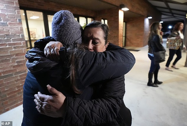 Dora Mendoza, right, is hugged by a friend as she leaves a meeting where Attorney General Merrick Garland shared a report on the findings of an investigation into the 2022 school shooting at Robb Elementary School