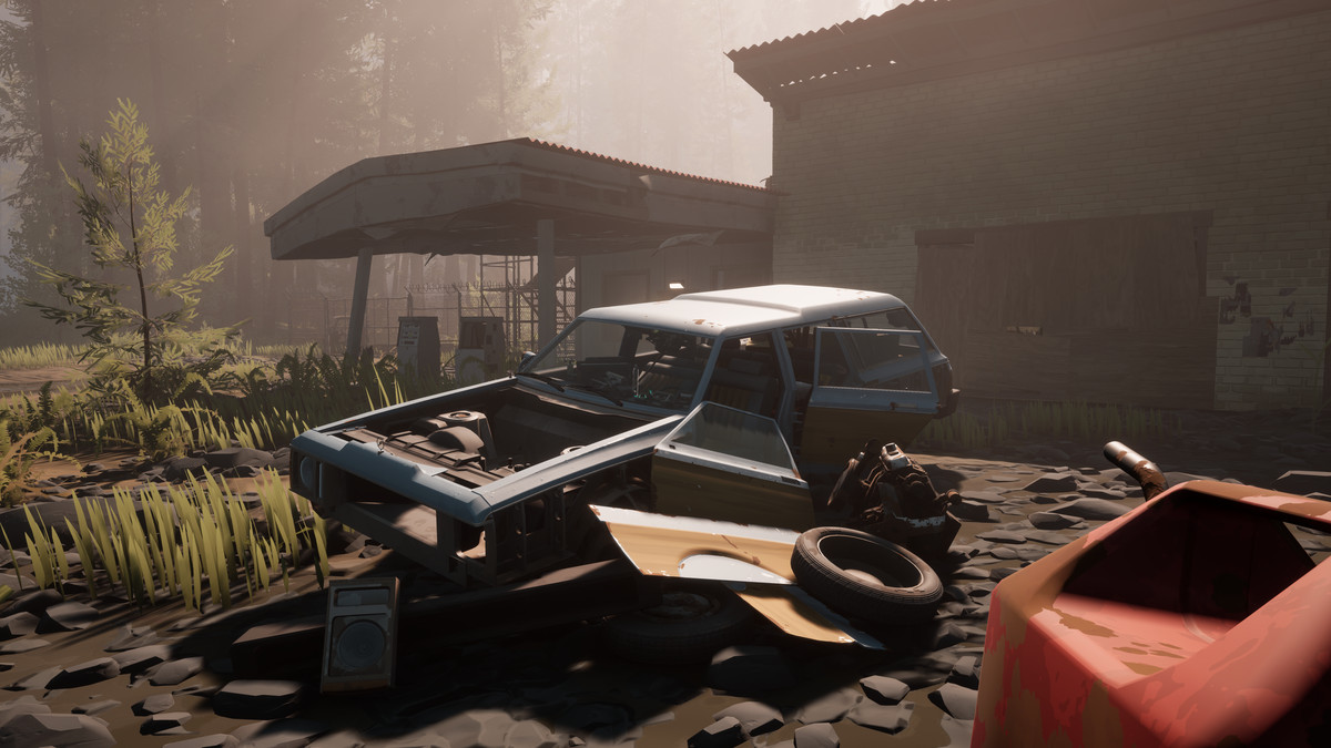 A dismantled station wagon, with a pile of panels, wheels and components next to it, sits next to an abandoned gas station on Pacific Drive