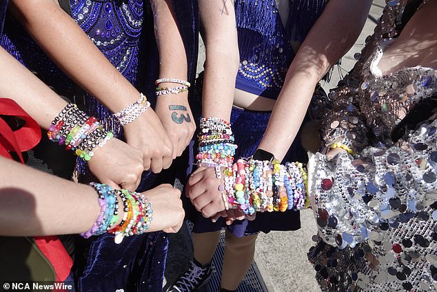 Taylor Swift fans pose with handmade bracelets ahead of a concert in Melbourne