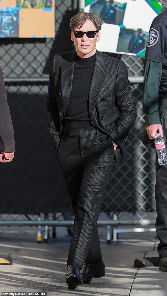 The actor stepped out in a black T-shirt under a black pinstripe suit and black pinstripe pants