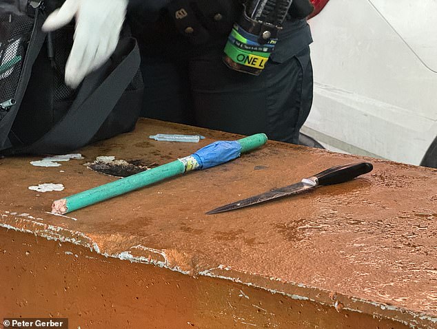 A bloody kitchen knife from the stabbing lay on a concrete block next to a broken post