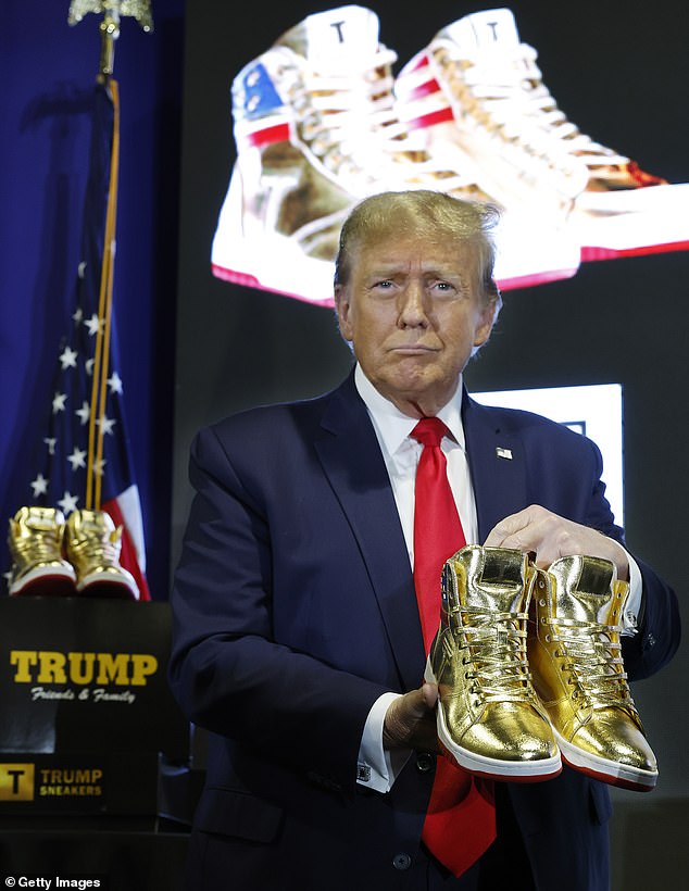 Republican presidential candidate and former President Donald Trump holds a pair of his new line of signature shoes after taking the stage during Sneaker Con at the Philadelphia Convention Center on February 17, 2024 in Philadelphia