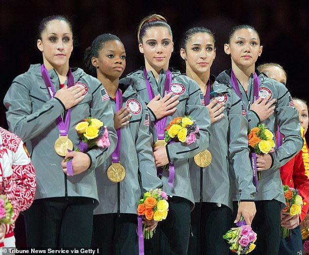 (L-R) Jordyn Wieber, Gabby Douglas, McKayla Maroney, Aly Raisman and Kyla Ross stand on the podium after winning team all-around gold in 2012 as the U.S. national anthem played