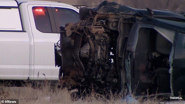 Images from the crash site show the car lying on its side with fragments scattered on the ground, surrounded by emergency services.