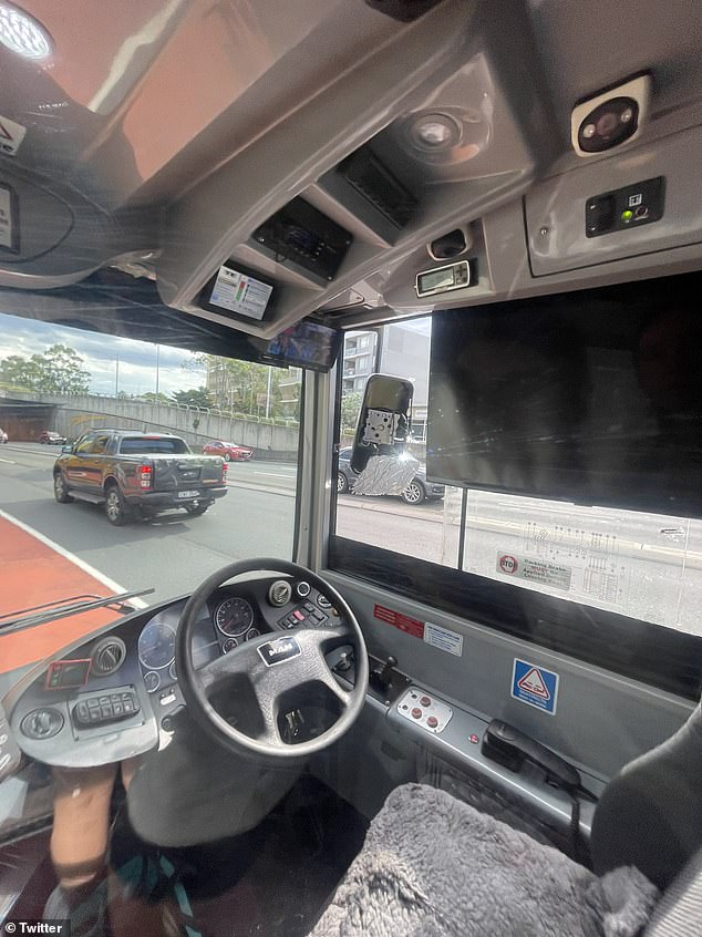 Photos from user @CarmenBartolo9 showed an empty bus driver's seat next to a damaged side mirror.  Pictured