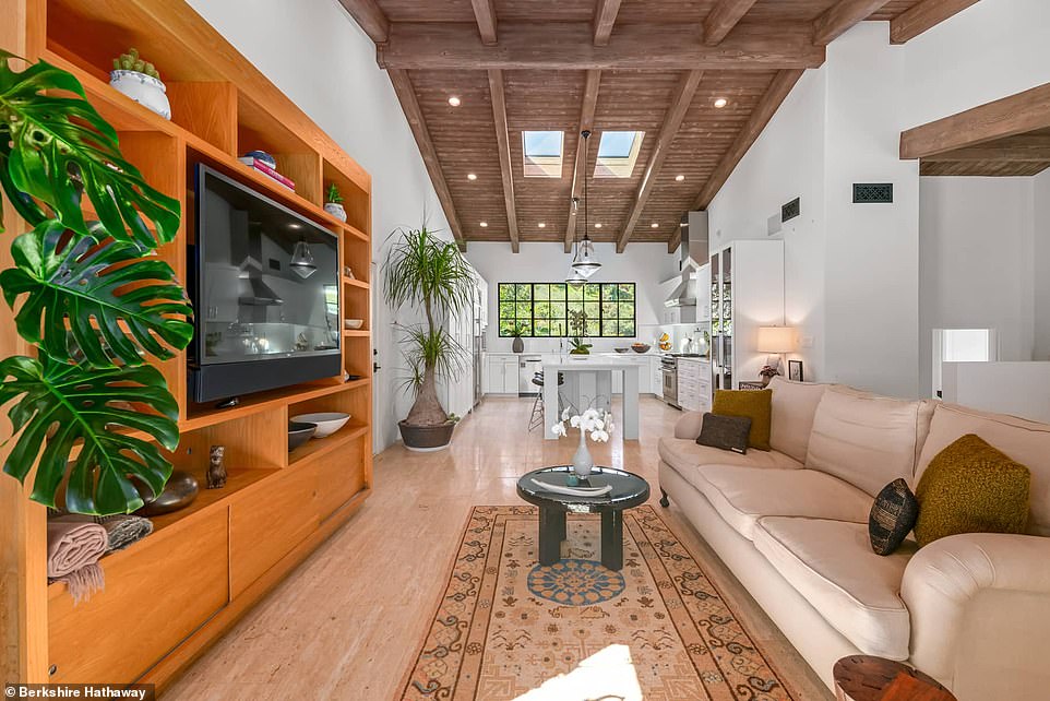 An inviting family room adjoins an eat-in kitchen adorned with high-end stainless steel appliances