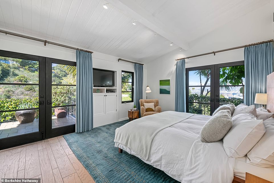 The master bedroom, conveniently located on the ground floor, has a private terrace