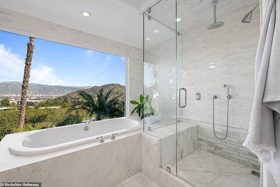 The primary bathroom is covered in beautiful white marble