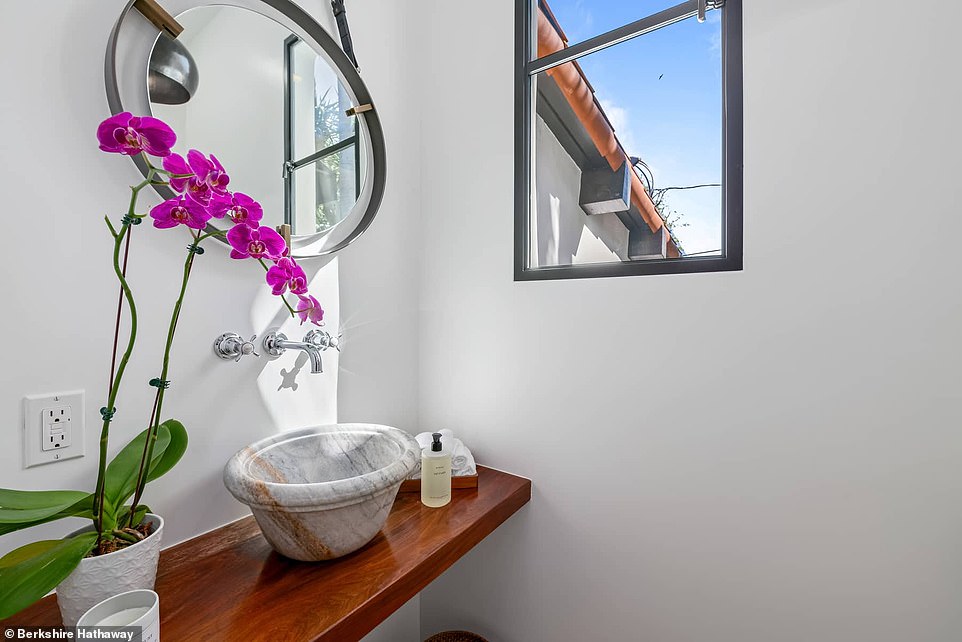 The bathroom has a cute window overlooking the backyard