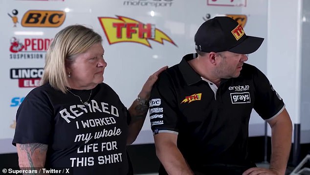 Team owner Betty Klimenko comforts Ryan as he struggles to compose himself in front of the cameras during the interview