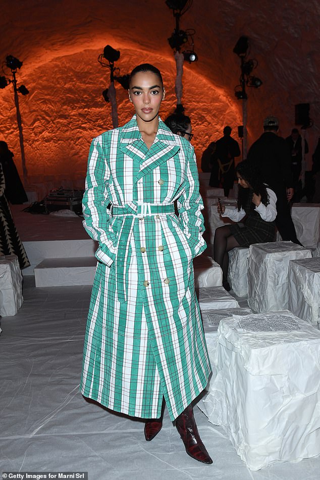 The internet star, 27, made a fashion statement in a pine green plaid double-breasted maxi coat dress