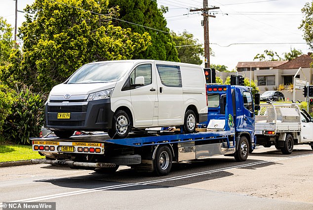 A white Toyota HiAce which police believe was used to transport the bodies of Mr Baird and Mr Davies was located at Grays Point near Cronulla.  In the photo it is being removed by the police