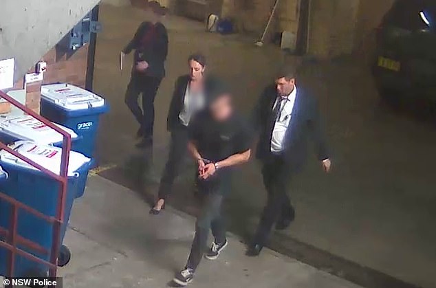 Lamarre-Condon was charged after handing himself over to police in Bondi following a massive manhunt (pictured, Lamarre-Condon is led away for questioning by detectives)