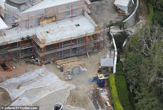 Aerial photos of the mega-mansion show construction equipment on the ground, but no workers in sight in April 2023