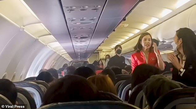 Shocked cabin crew rushed to the middle row of the Airbus A320 to douse the flames as nervous customers looked on