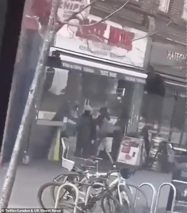 They appeared to be trying to open the door of the Taste More fish and chip shop where the man in turquoise had taken refuge