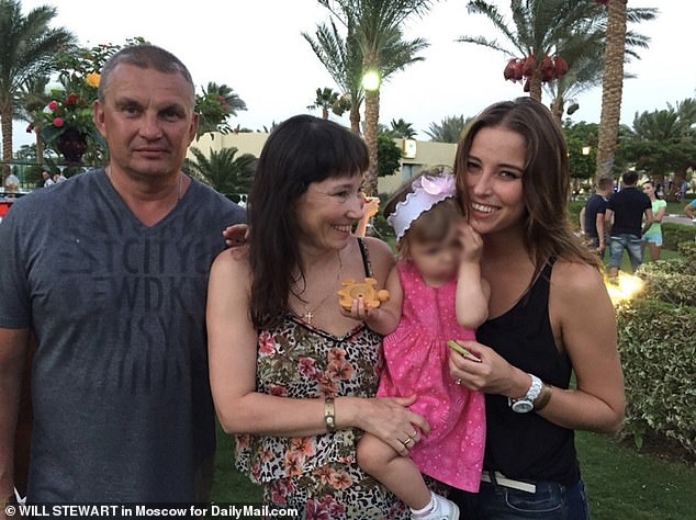 Ksenia Karelina, 33, pictured with her father Pavel, mother Liliya and younger sister, remains detained in Russia on charges of high treason