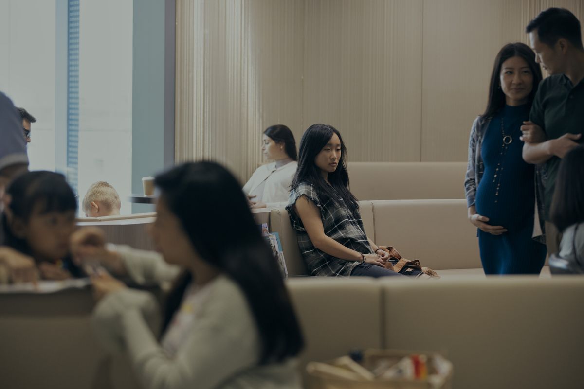 Mercy (Ji-young Yoo) sits alone in a waiting room