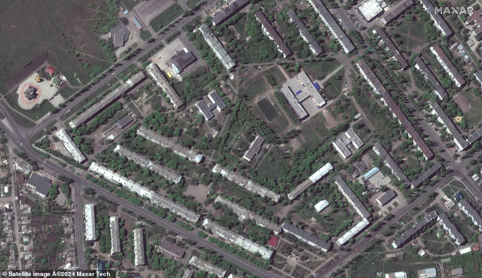 Satellite photos released by Maxar Technologies show school No. 12 and apartment buildings in the eastern city of Bakhmut, Donetsk Oblast, on May 8, 2022