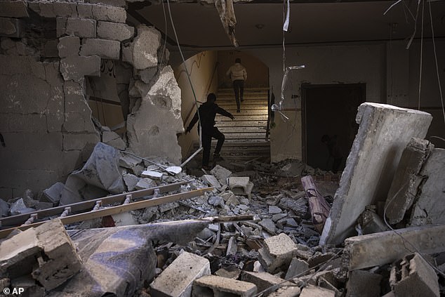 Palestinians check the destruction after an Israeli attack in Rafah, Gaza Strip on February 24