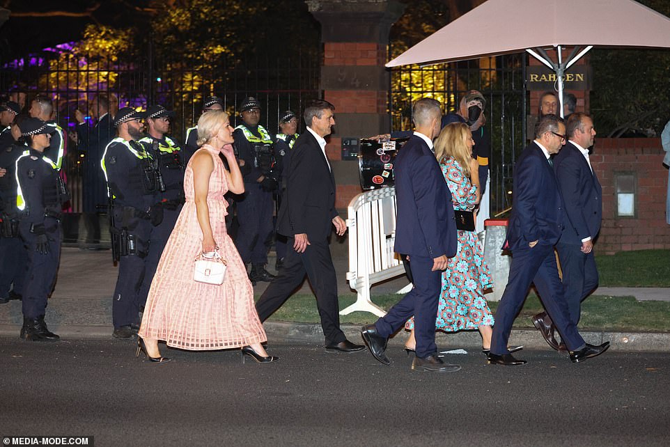 A group of guests leave the mansion as a heavy police presence is noticed at the main entrance