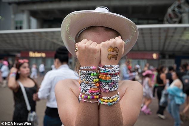 A concertgoer with arms full of friendship bracelets attends the second of four Taylor Swift Eras Tour dates at Sydney's ACCOR Stadium