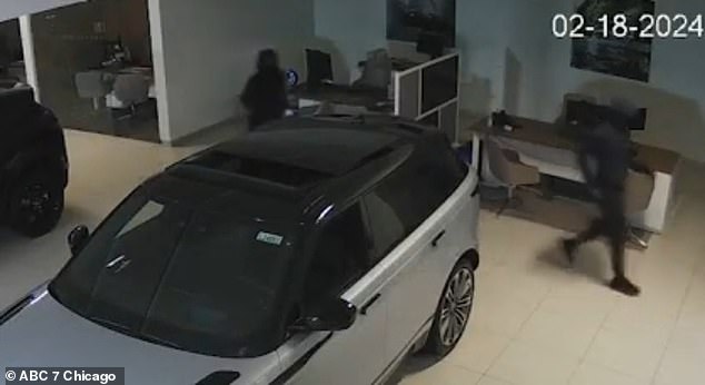 CCTV footage from inside the dealership shows four of the nine youths, all dressed in black, including masks and head coverings, rushing into the store