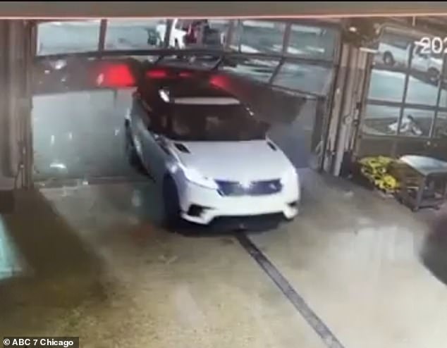Footage shows one of the thieves quickly driving a white car into a glass garage door