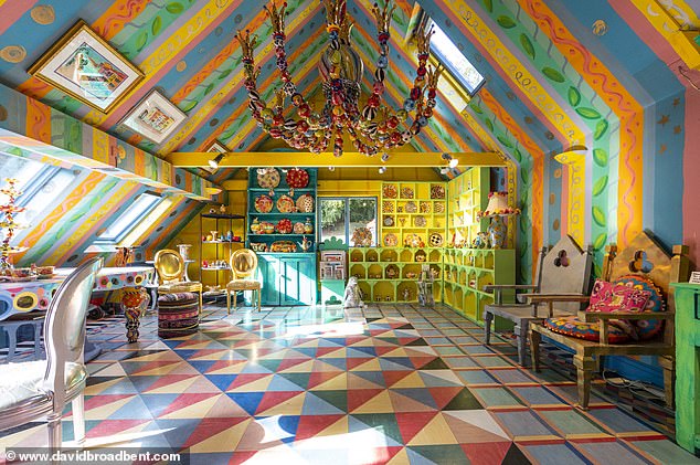 Mary's pottery studio - where she creates her Alice in Wonderland-inspired designs - features a multi-coloured striped ceiling with various floral patterns