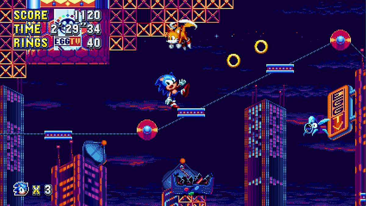 Sonic the Hedgehog balances precariously on a moving platform as Tails floats overhead in a screenshot from Sonic Mania