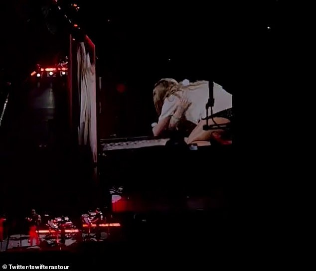 The youngster was overcome with emotion as she approached the edge of the stage before Swift got down on his knees and placed the hat on her head.